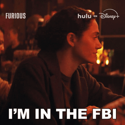 Woman Sitting At Table Saying I'm In The FBI GIF