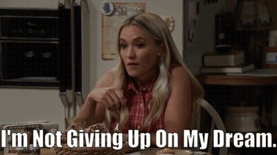 Woman Sitting at Table Saying I'm Not Giving Up on My Dream