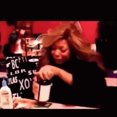 Woman Sitting At Table With BC Sign GIF