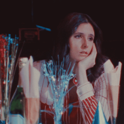 Woman Sitting At Table With Champagne And Decorations GIF