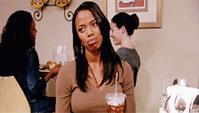 Woman Sitting At Table With Cup Of Soda GIF