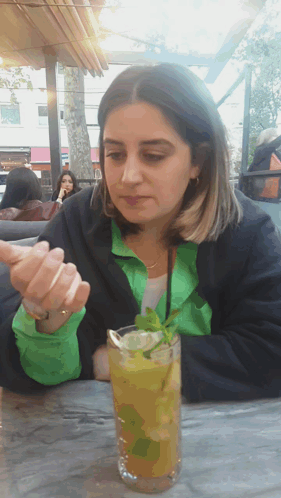 Woman Sitting At Table With Drink GIF