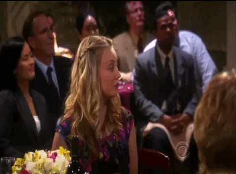 Woman Sitting At Table With Flowers GIF