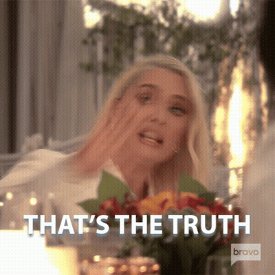Woman Sitting At Table With Flowers Says That's The Truth GIF