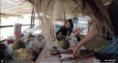 Woman Sitting At Table With Food And Bunched Jump Sign GIF