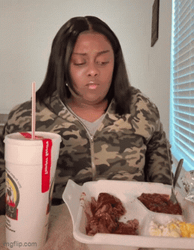 Woman Sitting At Table With Food And James Cup GIF