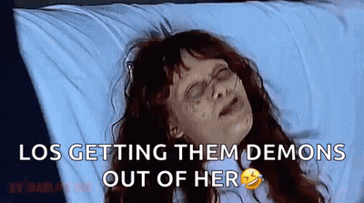 Woman Sitting At Table With Glass Of Milk In Mouth Talking To Another Woman GIF