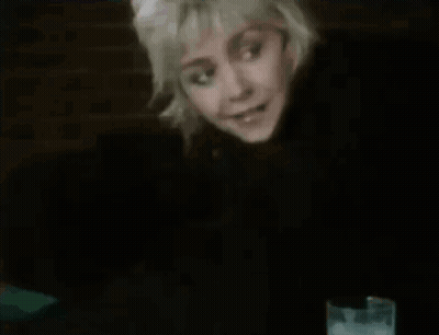 Woman Sitting At Table With Glass Of Water GIF