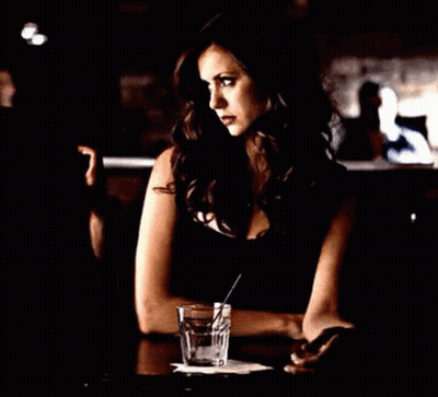 Woman Sitting at Table With Glass of Water