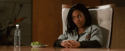 Woman Sitting At Table With Grapes And Water Bottle GIF