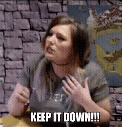 Woman Sitting At Table With Hands On Chest GIF