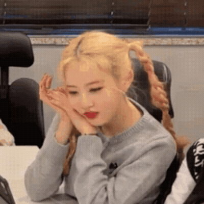 Woman Sitting At Table With Hands On Face GIF