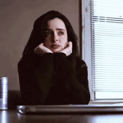 Woman Sitting At Table With Hands On Face And Laptop GIF