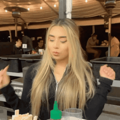 Woman Sitting At Table With Hot Sauce Bottle GIF