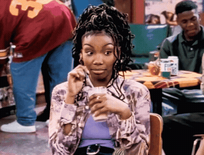 Woman Sitting At Table With Man In 33 Jersey GIF
