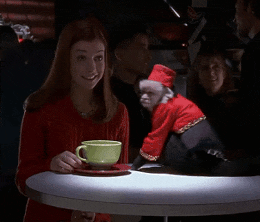 Woman Sitting At Table With Monkey In Santa Outfit GIF