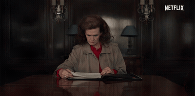 Woman Sitting At Table With Netflix Logo GIF