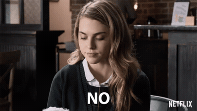 Woman Sitting At Table With Netflix Logo GIF