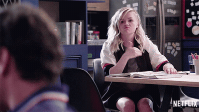 Woman Sitting At Table With Netflix Logo GIF