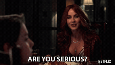 Woman Sitting At Table With Netflix Logo GIF