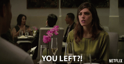 Woman Sitting At Table With Netflix Logo GIF