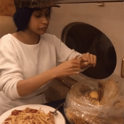 Woman Sitting At Table With Plate And Bag Of Food GIF
