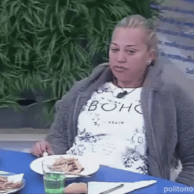 Woman Sitting At Table With Plates Of Food And Water GIF