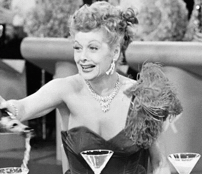 Woman Sitting At Table With Two Martinis GIF