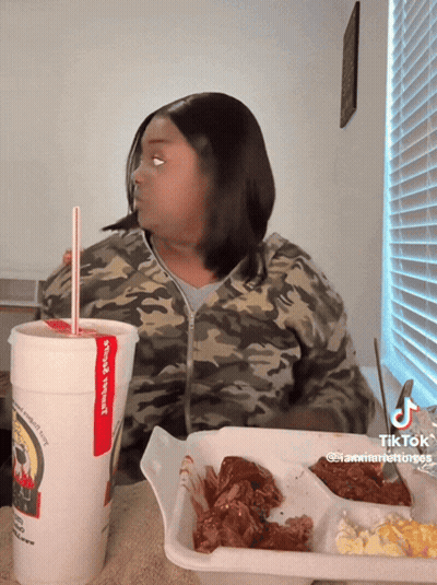 Woman Sitting At Table With Wings Special Cup GIF