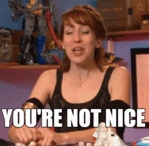 Woman Sitting At Table With Youre Not Nice Sign GIF