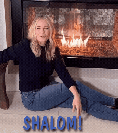Woman Sitting By Fireplace With Shalom On Floor GIF