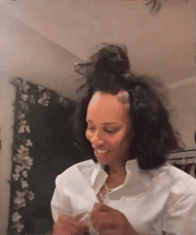 Woman Sitting By Window Wearing Jamaica Shirt GIF