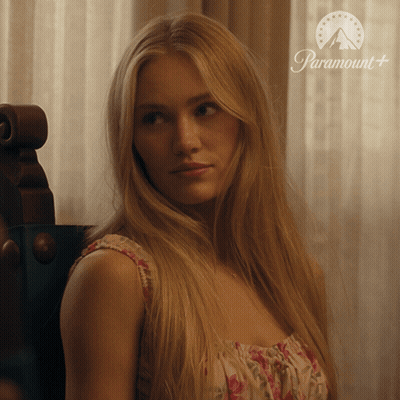 Woman Sitting By Window With Paramount Logo GIF