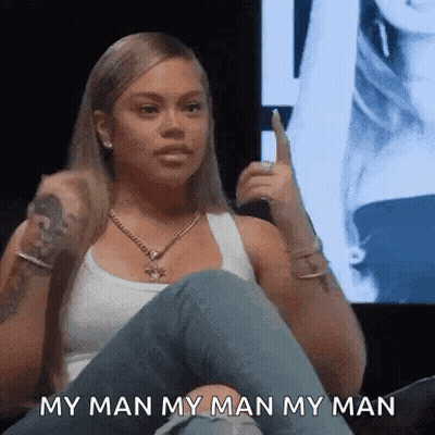 Woman Sitting Cross-Legged Holding Microphone GIF