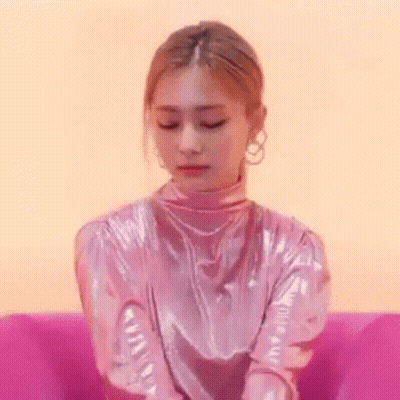 Woman Sitting Crossed Arms In Pink Chair GIF