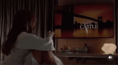 Woman Sitting Crossed-Legged On Bed GIF