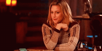 Woman Sitting Hand On Chin Looking At Camera GIF