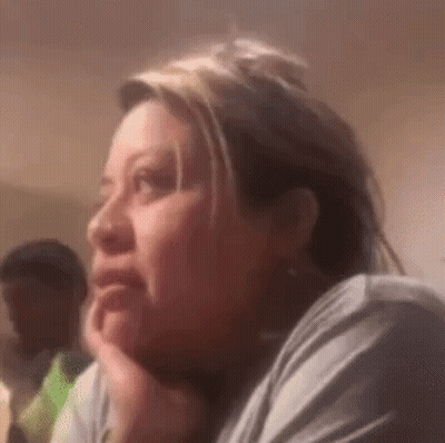 Woman Sitting Hand on Chin Looking at Camera