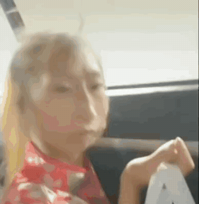 Woman Sitting In Back Seat Holding Paper GIF