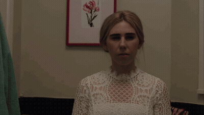 Woman Sitting In Bathroom With Shower Curtain And Aesop Bottle GIF