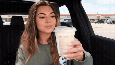 Woman Sitting In Car Holding Coffee GIF