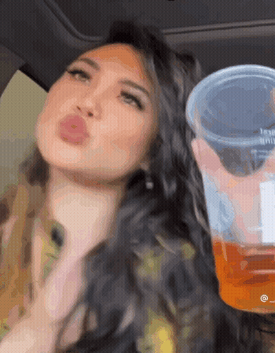 Woman Sitting In Car Holding Cup Saying Jesus GIF