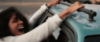 Woman Sitting In Car Holding Roof With Mouth Open GIF