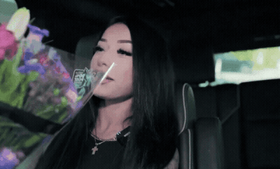 Woman Sitting In Car With Bouquet Of Flowers GIF