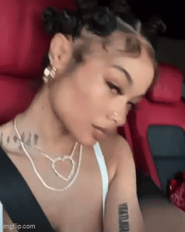 Woman Sitting In Car With Heart Necklace And Earrings GIF