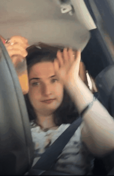 Woman Sitting In Car With Orange Juice GIF