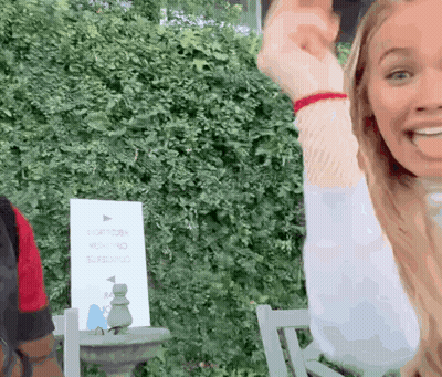 Woman Sitting In Chair Arms Up Sign Saying Right GIF