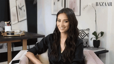 Woman Sitting In Chair Before Harper's Bazaar Ad GIF