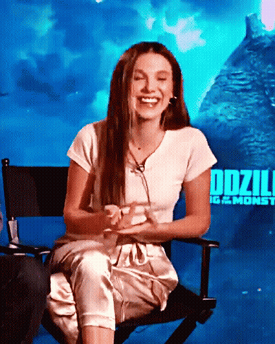 Woman Sitting In Chair By Godzilla Poster GIF