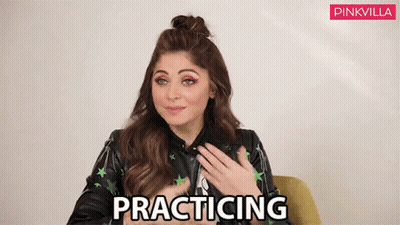 Woman Sitting In Chair Hands On Chest Practicing GIF